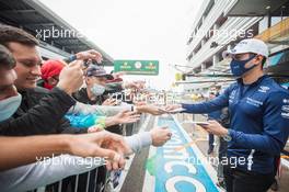 Nicholas Latifi (CDN) Williams Racing signs autographs for the fans in the pits. 23.09.2021. Formula 1 World Championship, Rd 15, Russian Grand Prix, Sochi Autodrom, Sochi, Russia, Preparation Day.