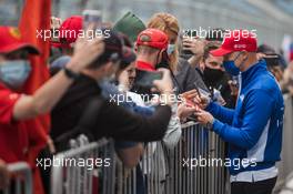Nikita Mazepin (RUS) Haas F1 Team signs autographs for the fans in the pits. 23.09.2021. Formula 1 World Championship, Rd 15, Russian Grand Prix, Sochi Autodrom, Sochi, Russia, Preparation Day.