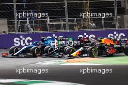 Esteban Ocon (FRA) Alpine F1 Team A521; Lewis Hamilton (GBR) Mercedes AMG F1 W12; and Max Verstappen (NLD) Red Bull Racing RB16B battle for the lead at the second race restart. 05.12.2021. Formula 1 World Championship, Rd 21, Saudi Arabian Grand Prix, Jeddah, Saudi Arabia, Race Day.
