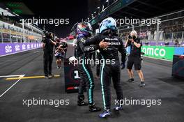 (L to R): Lewis Hamilton (GBR) Mercedes AMG F1 celebrates his pole position in qualifying parc ferme with team mate Valtteri Bottas (FIN) Mercedes AMG F1. 04.12.2021. Formula 1 World Championship, Rd 21, Saudi Arabian Grand Prix, Jeddah, Saudi Arabia, Qualifying Day.