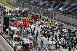 Lewis Hamilton (GBR) Mercedes AMG F1 W12, Lance Stroll (CDN) Aston Martin F1 Team AMR21, and Valtteri Bottas (FIN) Mercedes AMG F1 W12 on the grid. 27.06.2021. Formula 1 World Championship, Rd 8, Steiermark Grand Prix, Spielberg, Austria, Race Day.