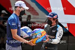 (L to R): Nicholas Latifi (CDN) Williams Racing with Fernando Alonso (ESP) Alpine F1 Team - helmet swap. 24.06.2021. Formula 1 World Championship, Rd 8, Steiermark Grand Prix, Spielberg, Austria, Preparation Day.
