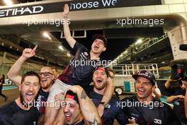Race winner and World Champion Max Verstappen (NLD) Red Bull Racing celebrates with the team. 12.12.2021. Formula 1 World Championship, Rd 22, Abu Dhabi Grand Prix, Yas Marina Circuit, Abu Dhabi, Race Day.