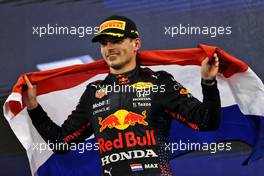Race winner and World Champion Max Verstappen (NLD) Red Bull Racing celebrates on the podium. 12.12.2021. Formula 1 World Championship, Rd 22, Abu Dhabi Grand Prix, Yas Marina Circuit, Abu Dhabi, Race Day.