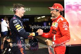 1st place and new World Champion, Max Verstappen (NLD) Red Bull Racing RB16B and Carlos Sainz Jr (ESP) Ferrari SF-21. 12.12.2021. Formula 1 World Championship, Rd 22, Abu Dhabi Grand Prix, Yas Marina Circuit, Abu Dhabi, Race Day.