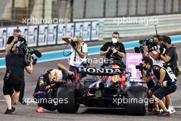 Race winner and World Champion Max Verstappen (NLD) Red Bull Racing RB16B celebrates in parc ferme. 12.12.2021. Formula 1 World Championship, Rd 22, Abu Dhabi Grand Prix, Yas Marina Circuit, Abu Dhabi, Race Day.