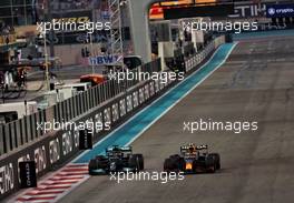 Lewis Hamilton (GBR) Mercedes AMG F1 W12 and Sergio Perez (MEX) Red Bull Racing RB16B battle for the lead of the race. 12.12.2021. Formula 1 World Championship, Rd 22, Abu Dhabi Grand Prix, Yas Marina Circuit, Abu Dhabi, Race Day.