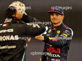 Max Verstappen (NLD) Red Bull Racing celebrates his pole position with second placed Lewis Hamilton (GBR) Mercedes AMG F1 in qualifying parc ferme. 11.12.2021. Formula 1 World Championship, Rd 22, Abu Dhabi Grand Prix, Yas Marina Circuit, Abu Dhabi, Qualifying Day.