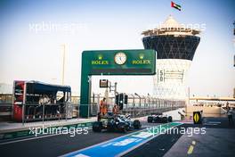 Lando Norris (GBR) McLaren MCL35M and Lance Stroll (CDN) Aston Martin F1 Team AMR21 leave the pits. 11.12.2021. Formula 1 World Championship, Rd 22, Abu Dhabi Grand Prix, Yas Marina Circuit, Abu Dhabi, Qualifying Day.