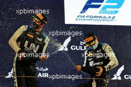 (L to R): Guanyu Zhou (CHN) Uni-Virtuosi Racing celebrates his second position on the podium with race winner Oscar Piastri (AUS) PREMA Racing. 27.03.2021. FIA Formula 2 Championship, Rd 1, Sprint Race 2, Sakhir, Bahrain, Saturday.