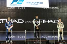 The podium (L to R): Robert Shwartzman (RUS) PREMA Racing, Guanyu Zhou (CHN) Uni-Virtuosi Racing, race winner; Ralph Boschung (SUI) Campos Racing, third. 11.12.2021. Formula 2 Championship, Rd 8, Yas Marina Circuit, Abu Dhabi, UAE, Sprint Race 2, Saturday.