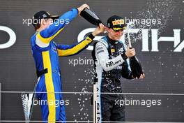 (L to R): second placed Felipe Drugovich (BRA) Uni-Virtuosi Racing with Oscar Piastri (AUS) PREMA Racing, celebrating his third position and the F2 Championship on the podium. 11.12.2021. Formula 2 Championship, Rd 8, Yas Marina Circuit, Abu Dhabi, UAE, Sprint Race 1, Saturday.