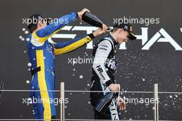 (L to R): Second placed Felipe Drugovich (BRA) Uni-Virtuosi Racing celebrates with third placed F2 champion Oscar Piastri (AUS) PREMA Racing on the podium. 11.12.2021. Formula 2 Championship, Rd 8, Yas Marina Circuit, Abu Dhabi, UAE, Sprint Race 1, Saturday.
