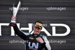 Guanyu Zhou (CHN) Uni-Virtuosi Racing celebrates his second position on the podium. 12.12.2021. Formula 2 Championship, Rd 8, Yas Marina Circuit, Abu Dhabi, UAE, Feature Race, Sunday.