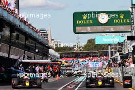 (L to R): Max Verstappen (NLD) Red Bull Racing RB18 and Sergio Perez (MEX) Red Bull Racing RB18 leave the pits. 08.04.2022. Formula 1 World Championship, Rd 3, Australian Grand Prix, Albert Park, Melbourne, Australia, Practice Day.