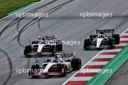 (L to R): Kevin Magnussen (DEN) Haas VF-22 leads Mick Schumacher (GER) Haas VF-22 and Lewis Hamilton (GBR) Mercedes AMG F1 W13. 09.07.2022. Formula 1 World Championship, Rd 11, Austrian Grand Prix, Spielberg, Austria, Sprint Day.