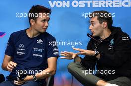(L to R): Alexander Albon (THA) Williams Racing and George Russell (GBR) Mercedes AMG F1 in the FIA Press Conference. 07.07.2022. Formula 1 World Championship, Rd 11, Austrian Grand Prix, Spielberg, Austria, Preparation Day.