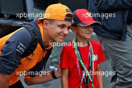 Lando Norris (GBR) McLaren with a young fan. 26.08.2022. Formula 1 World Championship, Rd 14, Belgian Grand Prix, Spa Francorchamps, Belgium, Practice Day.