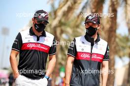 (L to R): Valtteri Bottas (FIN) Alfa Romeo F1 Team with team mate Guanyu Zhou (CHN) Alfa Romeo F1 Team. 18.03.2022. Formula 1 World Championship, Rd 1, Bahrain Grand Prix, Sakhir, Bahrain, Practice Day