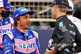 (L to R): Fernando Alonso (ESP) Alpine F1 Team and George Russell (GBR) Mercedes AMG F1 on the grid. 20.03.2022. Formula 1 World Championship, Rd 1, Bahrain Grand Prix, Sakhir, Bahrain, Race Day.