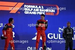 The podium (L to R): Carlos Sainz Jr (ESP) Ferrari, second; Charles Leclerc (MON) Ferrari, race winner; Lewis Hamilton (GBR) Mercedes AMG F1, third. 20.03.2022. Formula 1 World Championship, Rd 1, Bahrain Grand Prix, Sakhir, Bahrain, Race Day.