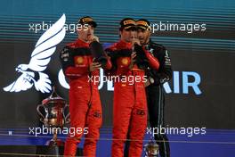 (L to R): Race winner Charles Leclerc (MON) Ferrari celebrates on the podium with second placed team mate Carlos Sainz Jr (ESP) Ferrari and Lewis Hamilton (GBR) Mercedes AMG F1. 20.03.2022. Formula 1 World Championship, Rd 1, Bahrain Grand Prix, Sakhir, Bahrain, Race Day.