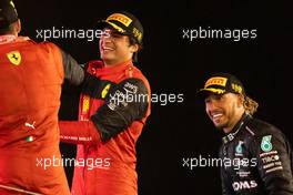 Carlos Sainz Jr (ESP) Ferrari and Lewis Hamilton (GBR) Mercedes AMG F1 on the podium. 20.03.2022. Formula 1 World Championship, Rd 1, Bahrain Grand Prix, Sakhir, Bahrain, Race Day.