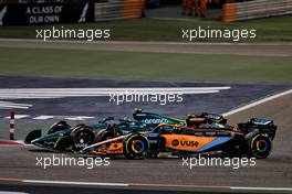 Nico Hulkenberg (GER) Aston Martin F1 Team Reserve Driver AMR22 and Lando Norris (GBR) McLaren MCL36 battle for position. 20.03.2022. Formula 1 World Championship, Rd 1, Bahrain Grand Prix, Sakhir, Bahrain, Race Day.