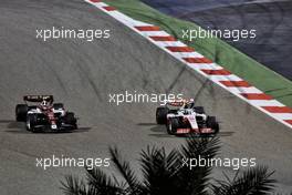 Guanyu Zhou (CHN) Alfa Romeo F1 Team C42 and Mick Schumacher (GER) Haas VF-22 battle for position. 20.03.2022. Formula 1 World Championship, Rd 1, Bahrain Grand Prix, Sakhir, Bahrain, Race Day.