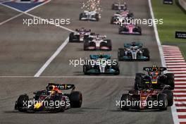 Max Verstappen (NLD) Red Bull Racing RB18 and Carlos Sainz Jr (ESP) Ferrari F1-75 battle for position. 20.03.2022. Formula 1 World Championship, Rd 1, Bahrain Grand Prix, Sakhir, Bahrain, Race Day.