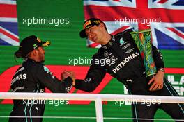 (L to R): Second placed Lewis Hamilton (GBR) Mercedes AMG F1 congratulates race winner and team mate George Russell (GBR) Mercedes AMG F1 on the podium. 13.11.2022. Formula 1 World Championship, Rd 21, Brazilian Grand Prix, Sao Paulo, Brazil, Race Day.