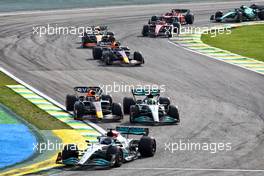 George Russell (GBR) Mercedes AMG F1 W13 leads as Max Verstappen (NLD) Red Bull Racing RB18 and Lewis Hamilton (GBR) Mercedes AMG F1 W13 make contact as they battle for position. 13.11.2022. Formula 1 World Championship, Rd 21, Brazilian Grand Prix, Sao Paulo, Brazil, Race Day.