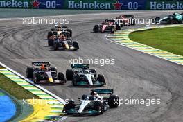 George Russell (GBR) Mercedes AMG F1 W13 leads as Max Verstappen (NLD) Red Bull Racing RB18 and Lewis Hamilton (GBR) Mercedes AMG F1 W13 make contact as they battle for position.  13.11.2022. Formula 1 World Championship, Rd 21, Brazilian Grand Prix, Sao Paulo, Brazil, Race Day.