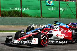 Fernando Alonso (ESP) Alpine F1 Team A522 and Guanyu Zhou (CHN) Alfa Romeo F1 Team C42 battle for position. 13.11.2022. Formula 1 World Championship, Rd 21, Brazilian Grand Prix, Sao Paulo, Brazil, Race Day.