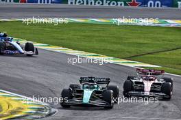 Lance Stroll (CDN) Aston Martin F1 Team AMR22 and Valtteri Bottas (FIN) Alfa Romeo F1 Team C42 battle for position. 13.11.2022. Formula 1 World Championship, Rd 21, Brazilian Grand Prix, Sao Paulo, Brazil, Race Day.