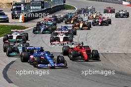 (L to R): Fernando Alonso (ESP) Alpine F1 Team A522 and Carlos Sainz Jr (ESP) Ferrari F1-75 battle for position at the start of the race. 19.06.2022. Formula 1 World Championship, Rd 9, Canadian Grand Prix, Montreal, Canada, Race Day.