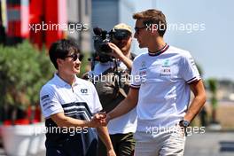 (L to R): Yuki Tsunoda (JPN) AlphaTauri with George Russell (GBR) Mercedes AMG F1. 21.07.2022. Formula 1 World Championship, Rd 12, French Grand Prix, Paul Ricard, France, Preparation Day.