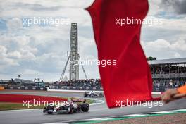Guanyu Zhou (CHN) Alfa Romeo F1 Team C42 passes a red flag. 01.07.2022. Formula 1 World Championship, Rd 10, British Grand Prix, Silverstone, England, Practice Day.