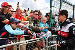 Guanyu Zhou (CHN) Alfa Romeo F1 Team signs autographs for the fans. 01.07.2022. Formula 1 World Championship, Rd 10, British Grand Prix, Silverstone, England, Practice Day.
