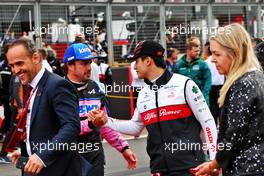 (L to R): Fernando Alonso (ESP) Alpine F1 Team with Guanyu Zhou (CHN) Alfa Romeo F1 Team on the grid. 03.07.2022. Formula 1 World Championship, Rd 10, British Grand Prix, Silverstone, England, Race Day.