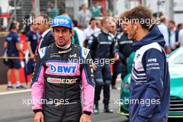 (L to R): Fernando Alonso (ESP) Alpine F1 Team and Pierre Gasly (FRA) AlphaTauri on the grid. 03.07.2022. Formula 1 World Championship, Rd 10, British Grand Prix, Silverstone, England, Race Day.