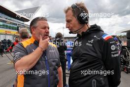 (L to R): Zak Brown (USA) McLaren Executive Director with Laurent Rossi (FRA) Alpine Chief Executive Officer on the grid. 03.07.2022. Formula 1 World Championship, Rd 10, British Grand Prix, Silverstone, England, Race Day.