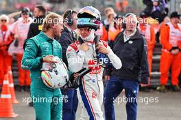 (L to R): Sebastian Vettel (GER) Aston Martin F1 Team with Mick Schumacher (GER) Haas F1 Team in parc ferme. 03.07.2022. Formula 1 World Championship, Rd 10, British Grand Prix, Silverstone, England, Race Day.