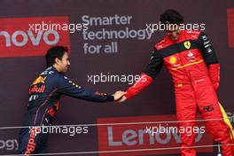 Sergio Perez (MEX) Red Bull Racing RB18 with Carlos Sainz Jr (ESP) Ferrari F1-75. 03.07.2022. Formula 1 World Championship, Rd 10, British Grand Prix, Silverstone, England, Race Day.