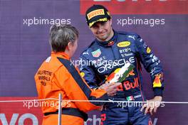 Sergio Perez (MEX) Red Bull Racing is presented the second placed trophy on the podium by Nadine Lewis (GBR) British Motorsports Marshals Club Chair. 03.07.2022. Formula 1 World Championship, Rd 10, British Grand Prix, Silverstone, England, Race Day.