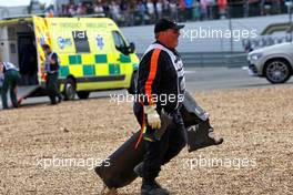 Debris is removed by a marshal at the start of the race. 03.07.2022. Formula 1 World Championship, Rd 10, British Grand Prix, Silverstone, England, Race Day.