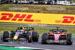 Charles Leclerc (MON) Ferrari F1-75 and Sergio Perez (MEX) Red Bull Racing RB18 battle for position. 03.07.2022. Formula 1 World Championship, Rd 10, British Grand Prix, Silverstone, England, Race Day.