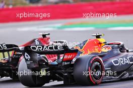 Sergio Perez (MEX) Red Bull Racing RB18 and Charles Leclerc (MON) Ferrari F1-75 battle for position. 03.07.2022. Formula 1 World Championship, Rd 10, British Grand Prix, Silverstone, England, Race Day.