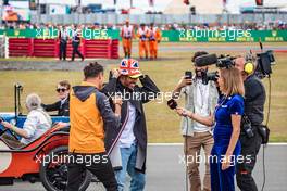 Lewis Hamilton (GBR) Mercedes AMG F1 and Lando Norris (GBR) McLaren with Natalie Pinkham (GBR) Sky Sports Presenter on the drivers parade. 03.07.2022. Formula 1 World Championship, Rd 10, British Grand Prix, Silverstone, England, Race Day.