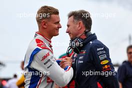 (L to R): Mick Schumacher (GER) Haas F1 Team and Christian Horner (GBR) Red Bull Racing Team Principal on the grid. 31.07.2022. Formula 1 World Championship, Rd 13, Hungarian Grand Prix, Budapest, Hungary, Race Day.